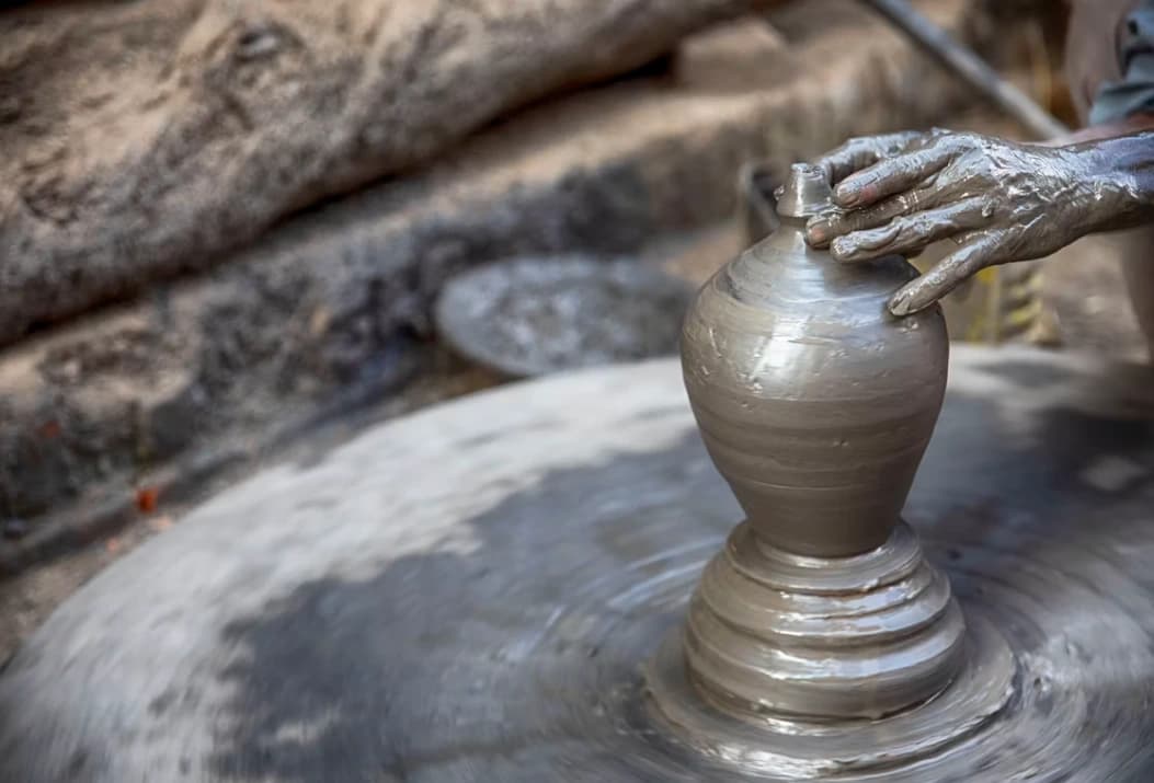 Potter's Square in Bhaktapur with artisans crafting traditional clay pottery in the sun