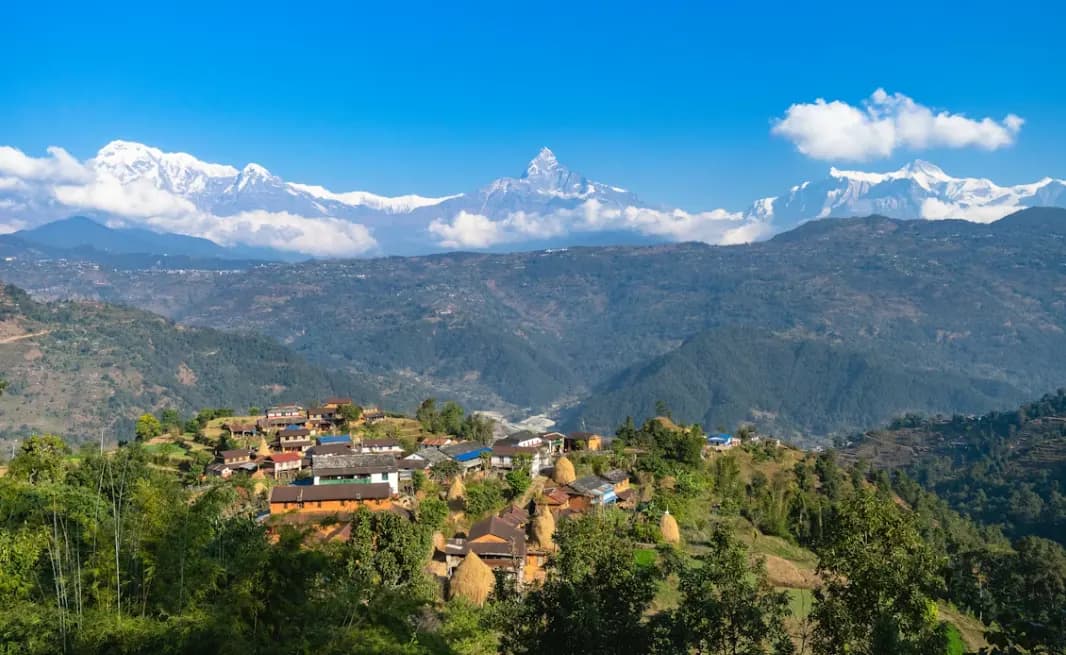 Sunrise over Pokhara lakeside with colorful boats and Annapurna range in the distance