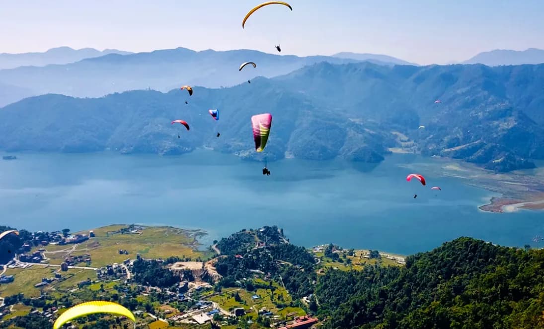 Phewa Lake in Pokhara with the Annapurna mountain range reflected in calm waters at sunrise