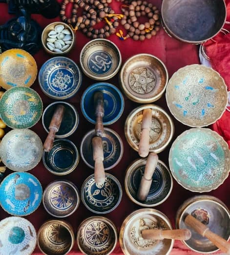 Traditional Tibetan singing bowls used for sound healing meditation in Nepal wellness retreat