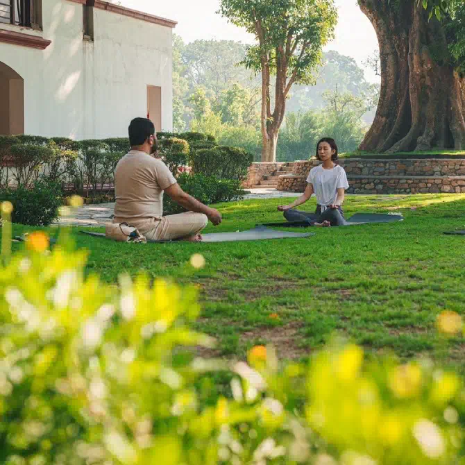 Solo woman traveler practicing yoga during a wellness retreat in the lush green outdoors of Nepal