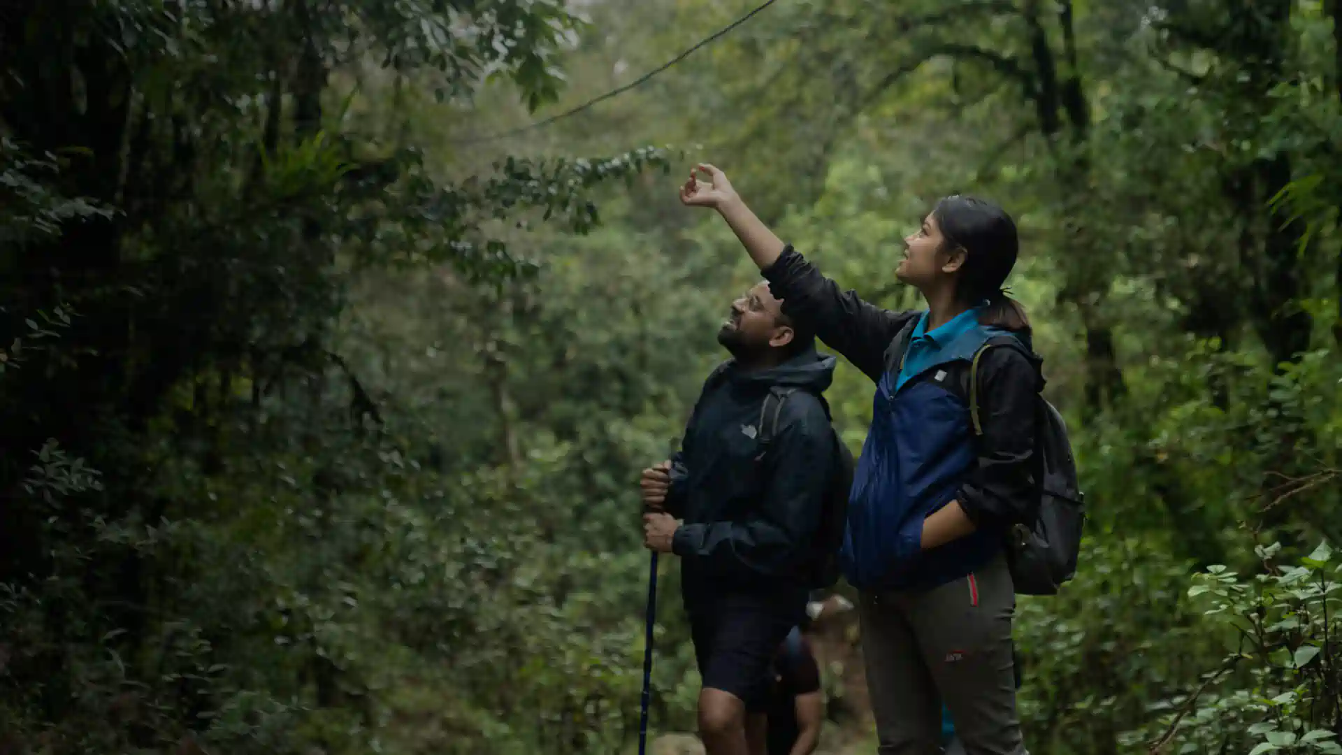 SASANE Sisterhood survivor guides leading a trekking group through the green hills of Nepal